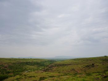 Scenic view of landscape against cloudy sky