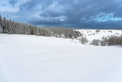 Scenic view of snow covered landscape against sky