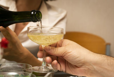 Close-up of hand holding glass of juice