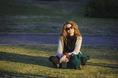 Young woman sitting on field