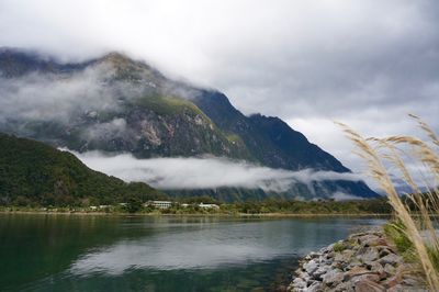 Scenic view of clouds and mountains against sky in fjord 