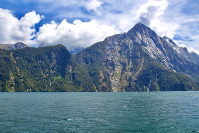 Scenic view of sea and mountains against sky