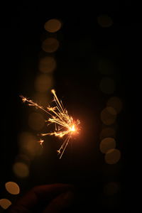 Low angle view of firework display at night