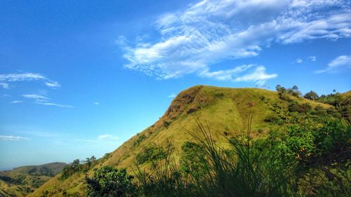 Low angle view of mountain against blue sky