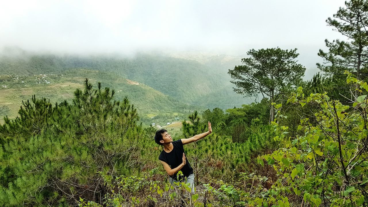 real people, nature, tree, growth, outdoors, scenics, one person, mountain, day, beauty in nature, plant, lifestyles, sky, green color, landscape, full length, young adult, people