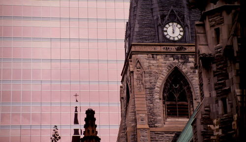 Low angle view of clock tower against building