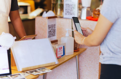 Midsection of woman using mobile phone