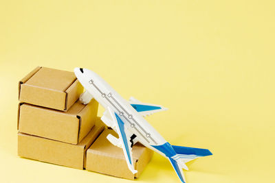 Close-up of model airplane against yellow background