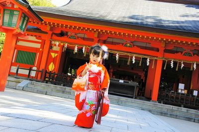 View of woman in front of building