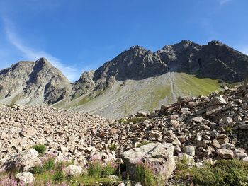 Panoramic view of landscape and mountains against blue sky