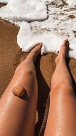 Low section of woman legs on beach
