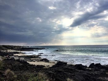 Scenic view of sea against cloudy sky