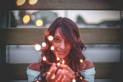 Portrait of young woman holding umbrella