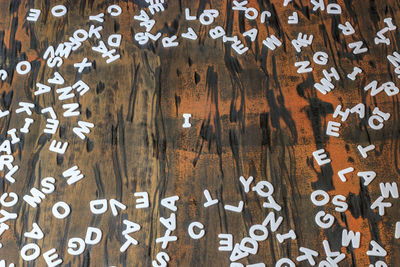 Full frame shot of alphabets on wooden table