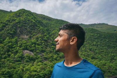 Young indian boy enjoying the view of green mountains.