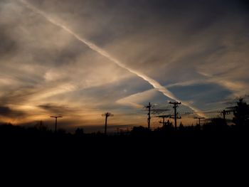 Silhouette of trees against sky at sunset