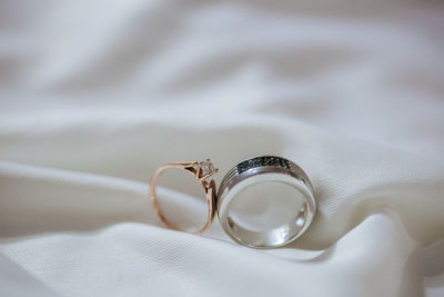Close-up of wedding rings on textile