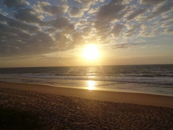 Scenic view of beach against sky during sunset