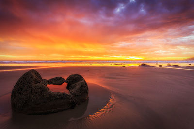 Scenic view of beach against sky during sunset