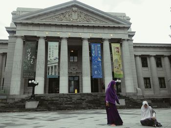 People in front of historic building