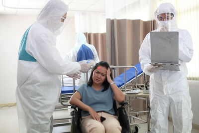 Doctors examining patient in hospital