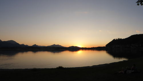 Scenic view of lake at sunset