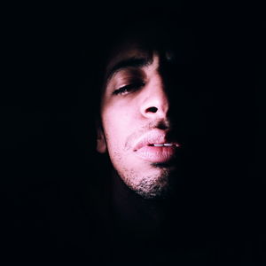 Portrait of man against black background