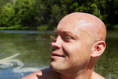 Close-up of butterfly on man nose