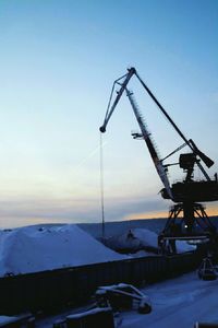 Cranes against clear sky during winter