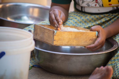 Close-up of person preparing food on table