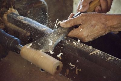 Close-up of hand chiseling wood