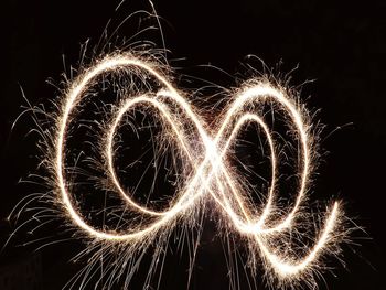 Low angle view of firework display at night