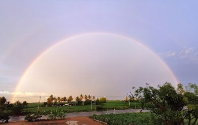 Scenic view of rainbow against sky at sunset