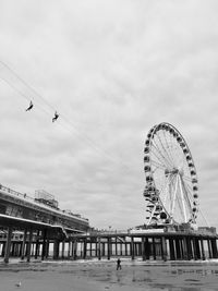 Low angle view of ferris wheel against sky