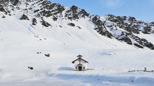 Chapel against snowcapped mountain