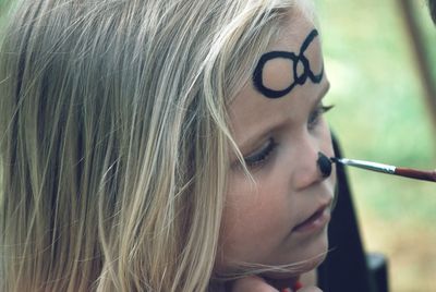 Close-up of cute girl with face paint