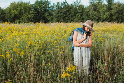 Rear view of woman standing on field