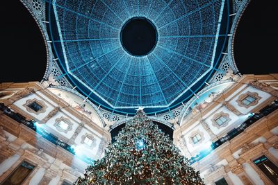 Low angle view of illuminated chandelier at night