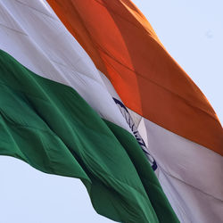 India flag flying high at connaught place with pride in blue sky, india flag fluttering