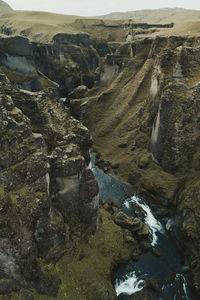 Aerial view of river flowing through rocks