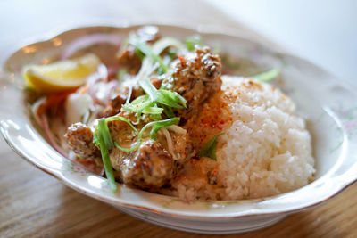 Close-up of karaage don served with rice on table