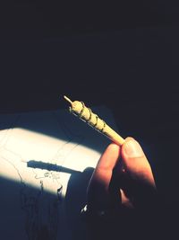 Close-up of hand holding cigarette