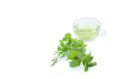 Glass of drink against white background