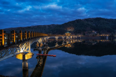 Illuminated buildings in lake