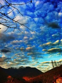 Scenic view of mountains against cloudy sky