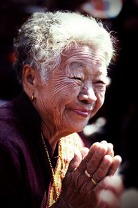 Senior woman with hands clasped