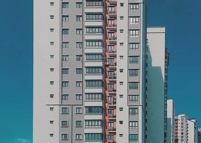 Low angle view of buildings against blue sky