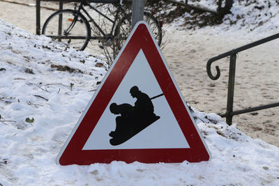 Close-up of snow covered road sign