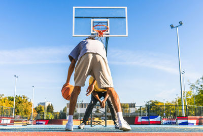 Low section of man standing on field