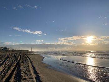 Scenic view of beach against sky during sunset